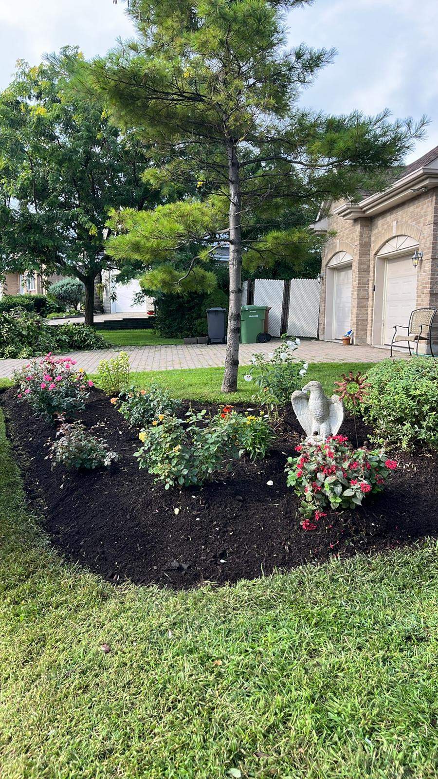 Flower bed with garden statue